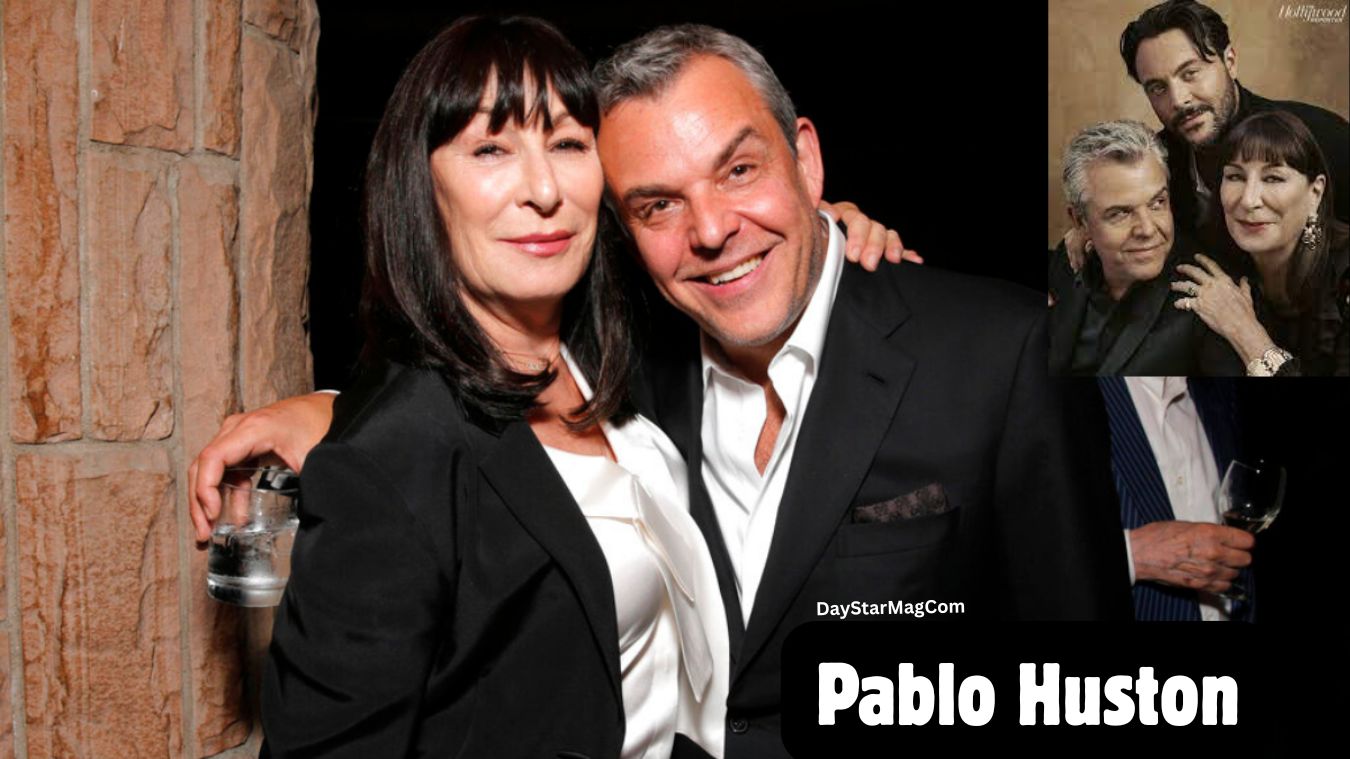 A middle-aged woman and a middle-aged man are standing close together and smiling at the camera. The woman has straight dark hair with bangs and is wearing a black blazer over a white blouse. The man beside her is wearing a black blazer and white shirt, with his arm around her. In the upper-right corner of the image, there is a smaller inset photo showing the same woman posing with two men. At the bottom of the main image, the text “Pablo Huston” and “DayStarMagCom” is displayed.