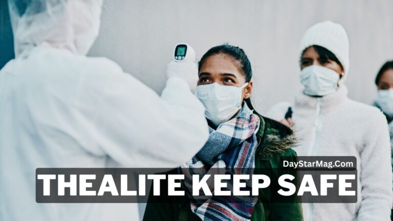 A healthcare worker wearing protective gear checks the temperature of a masked woman standing in line outdoors. Other people wearing face masks wait behind her. A large text overlay reads “THEALITE KEEP SAFE” with “DayStarMag.com” displayed on the image.