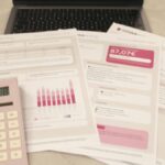 “Smart money financial planning with calculator, bills, and budget documents on a desk.”